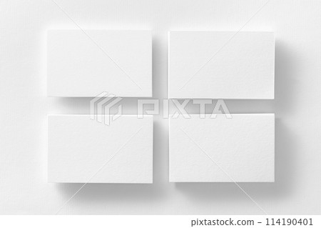 Mockup of four white business cards stacks arranged in rows at white design paper background. 114190401