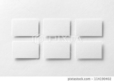 Mockup of white business cards arranged in rows at white design paper background. 114190402