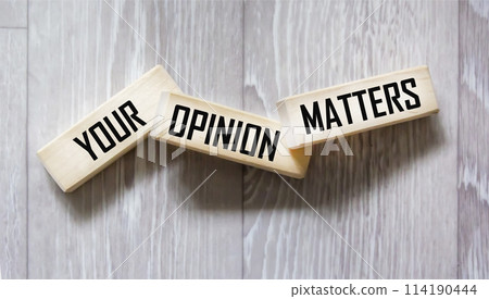 YOUR OPINION MATTERS is written on wooden blocks on a gray background. close-up 114190444