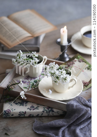 White flowers in a coffee cup White flowers in a coffee cup 114190500