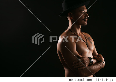 Strong Athletic Sexy Muscular Man on Black Background 114191045