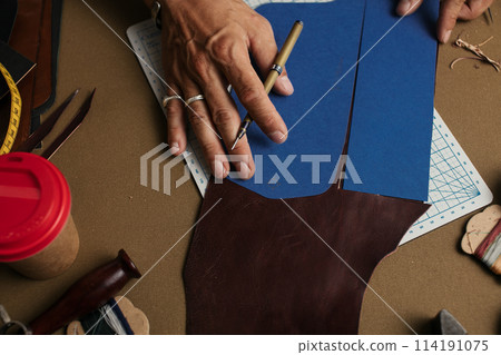 Working process of producing hand made leather wallet in the leather workshop. 114191075