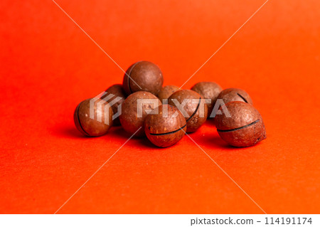 healthy macadamia nut for health on a red background 114191174