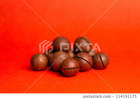macadamia nut on a red background. delicious and healthy nut 114191175