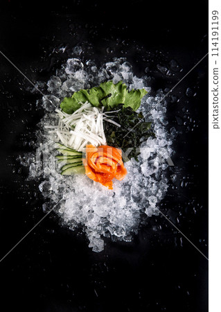 fish and tuna on ice on black background 114191199