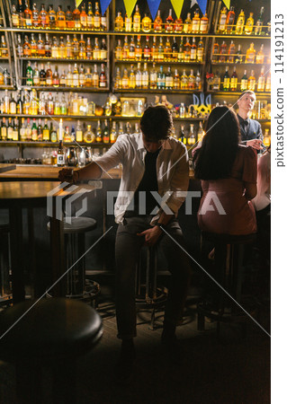 Tired drunk man with shot glass sits at round table in bar Tired drunk man with shot glass sits at round table in bar 114191213