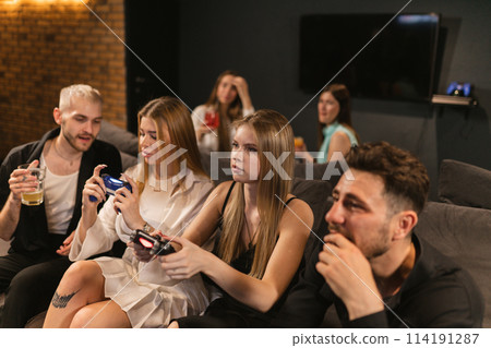 Men and women fully engrossed in unfolding drama of game Men and women fully engrossed in unfolding drama of game 114191287