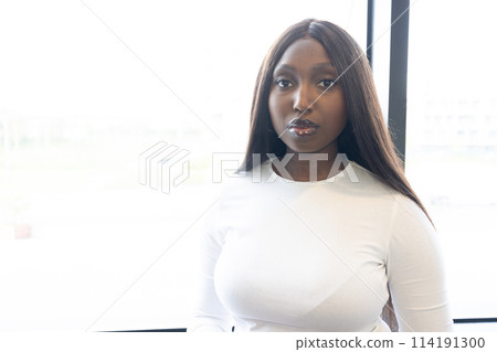 Portrait of a Young Black Woman in Modern Urban Setting 114191300