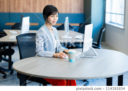 Female operator working in the office Female operator working in the office 114191834