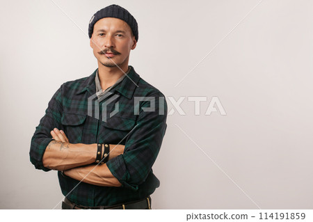 Craftsman standing confidently with his arms folded isolated over white wall. Craftsman standing confidently with his arms folded isolated over white wall. 114191859