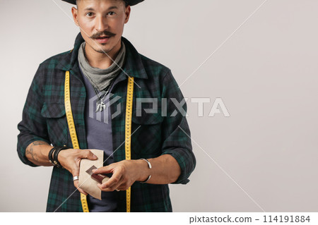 Portrait of shoemaker hammering on a shoe 114191884