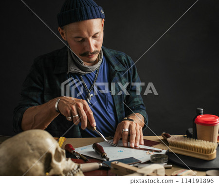 Shoemaker is repairing shoe. Shoemaker sews shoes. Cobbler workshop. Shoemaker is repairing shoe. Shoemaker sews shoes. Cobbler workshop. 114191896