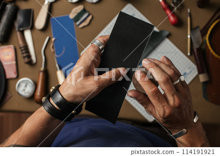 Working process of producing hand made leather wallet in the leather workshop. 114191921