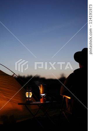 Man enjoying camping at sunset 114191973