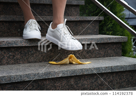 Foot stepping on a banana peel on steps Foot stepping on a banana peel on steps 114192378