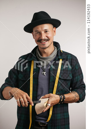 Closeup of confident happy man over studio white background Closeup of confident happy man over studio white background 114192433