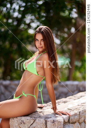 Close-up portrait of beautiful sexy girl in green swimsuit Close-up portrait of beautiful sexy girl in green swimsuit 114192446