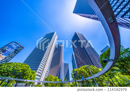 Shinjuku, Tokyo cityscape in Japan. View of Nishi-Shinjuku sign at the intersection behind Shinjuku Police Station and skyscrapers, April 28th Shinjuku, Tokyo cityscape in Japan. View of Nishi-Shinjuku sign at the intersection behind Shinjuku Police Station and skyscrapers, April 28th 114192970