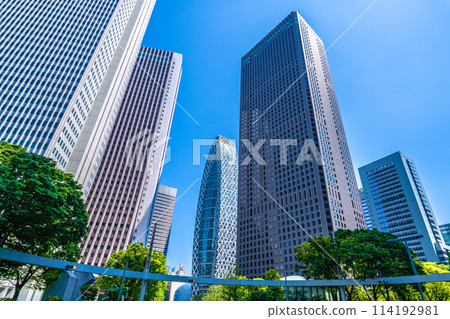 Shinjuku, Tokyo cityscape in Japan. View of Nishi-Shinjuku sign at the intersection behind Shinjuku Police Station and skyscrapers, April 28th Shinjuku, Tokyo cityscape in Japan. View of Nishi-Shinjuku sign at the intersection behind Shinjuku Police Station and skyscrapers, April 28th 114192981