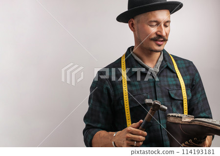 Shoemaker in studio. Unrecognizable shoemaker performs shoes in the studio craft 114193181