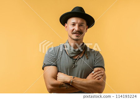 Happy man with moustache wearing hat isolated over yellow background. Happy man with moustache wearing hat isolated over yellow background. 114193224