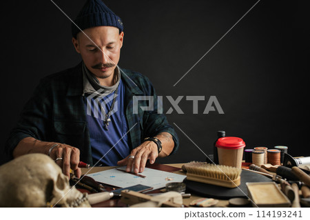 Shoemaker is repairing shoe. Shoemaker sews shoes. Cobbler workshop. Shoemaker is repairing shoe. Shoemaker sews shoes. Cobbler workshop. 114193241