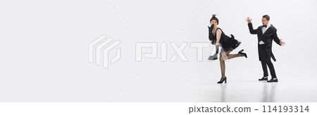 Emotional man looking at beautiful woman dancing and expressing his interest and admiration isolated over white studio background 114193314