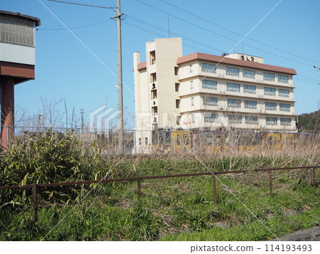 Railroad tracks and buildings visible beyond the railway Railroad tracks and buildings visible beyond the railway 114193493