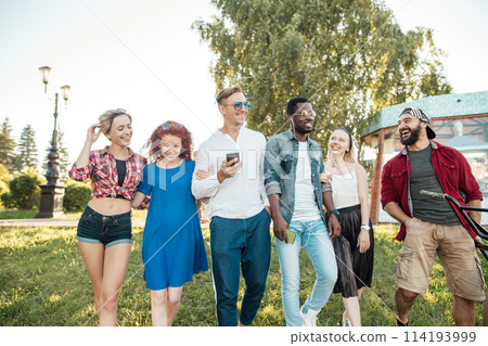 Best multiracial friends hanging out together and walking in park in summer day. 114193999