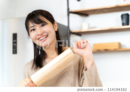 Woman cooking in the kitchen Woman cooking in the kitchen 114194162