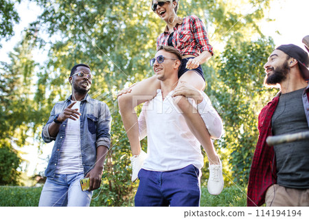 Multicultural group of friends walking together and having fun day outdoors. Multicultural group of friends walking together and having fun day outdoors. 114194194