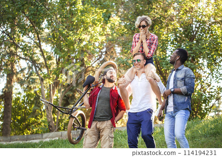 Best multiracial friends hanging out together and walking in park in summer day. 114194231