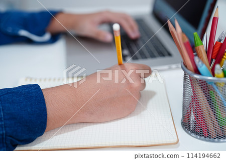 Asian teenage student write homework with laptop computer, learning university education concept. Asian teenage student write homework with laptop computer, learning university education concept. 114194662