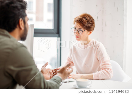 investment advisor businesswoman sitting at computer and consulting with young professional man or client 114194683