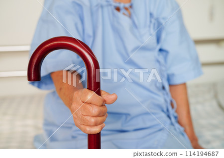 Asian elderly disability woman patient holding walking stick in wrinkled hand at hospital. Asian elderly disability woman patient holding walking stick in wrinkled hand at hospital. 114194687