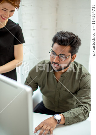 creative designers manager showing new startup idea on monitor for his female boss 114194733