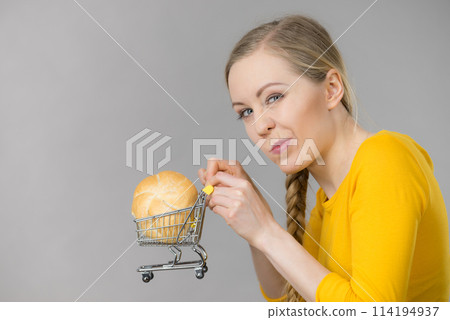 Woman holding shopping cart with bread 114194937