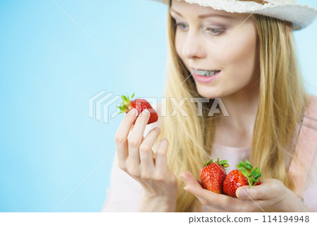 Young woman with fresh strawberries Young woman with fresh strawberries 114194948