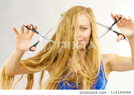 Girl with scissors for haircutting Girl with scissors for haircutting 114194999