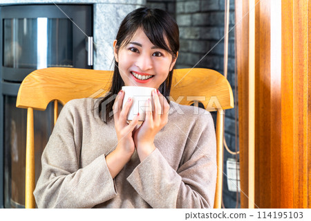 Woman relaxing in a rocking chair 114195103