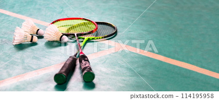 White badminton shuttlecocks and badminton rackets on green floor indoor badminton court soft and selective focus on shuttlecocks and the rackets White badminton shuttlecocks and badminton rackets on green floor indoor badminton court soft and selective focus on shuttlecocks and the rackets 114195958