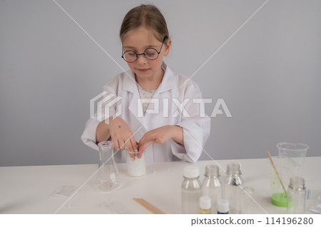 A Caucasian girl in glasses and a white coat does chemical experiments on a white background. 114196280