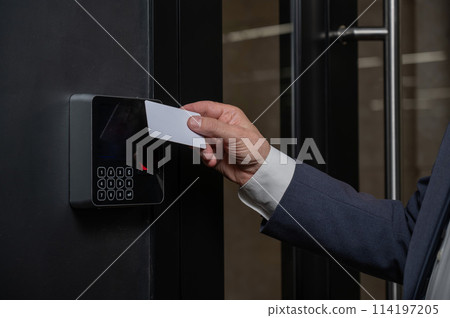 A man opens the door with a card. Modern electronic lock. Keyless Entry 114197205