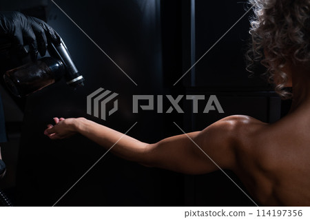 The master applies tinting paint to the woman's hand. Instant tanning procedure The master applies tinting paint to the woman's hand. Instant tanning procedure 114197356
