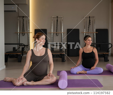 Two pregnant women doing yoga. Preparing for the birth of a child.  114197382