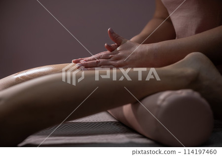 Close-up of a woman's leg massage in a salon. Close-up of a woman's leg massage in a salon. 114197460