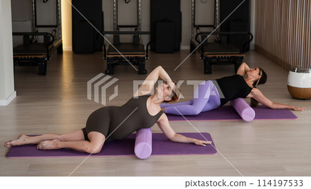 Two pregnant women doing yoga. Preparing for the birth of a child.  114197533