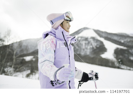 Elementary school girl skiing on a snowy mountain Elementary school girl skiing on a snowy mountain 114197701