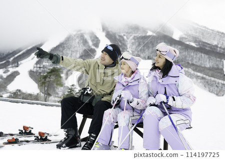 Family, parents and daughter enjoying skiing on snowy mountain Family, parents and daughter enjoying skiing on snowy mountain 114197725