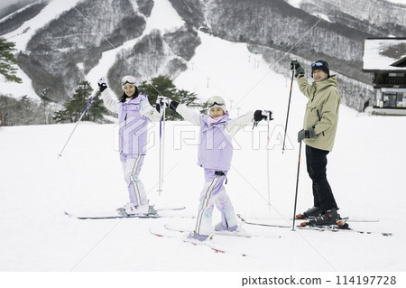 Family, parents and daughter enjoying skiing on snowy mountain Family, parents and daughter enjoying skiing on snowy mountain 114197728